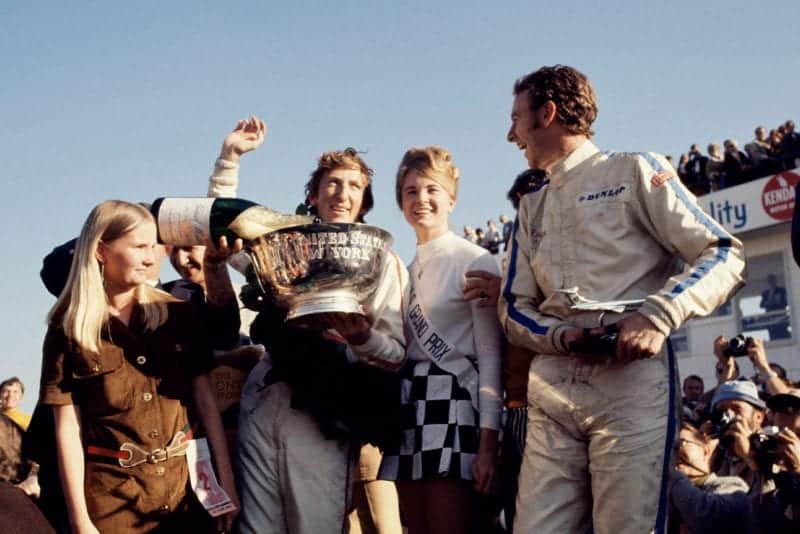 Jochen Rindt celebrates on the podium after winning the 1969 United States Grand Prix