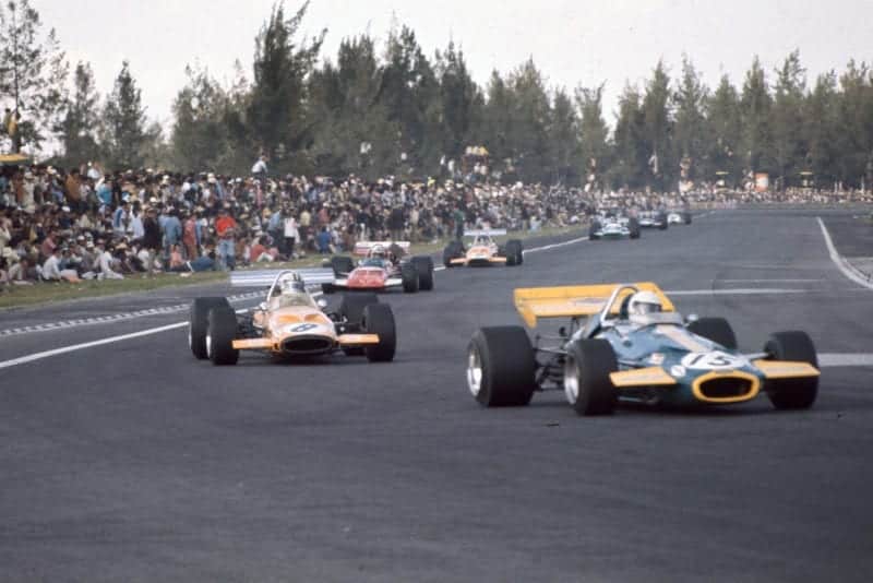 Large crowds gather dangerously near to the track as the race continues at the 1970 Mexican Grand Prix.