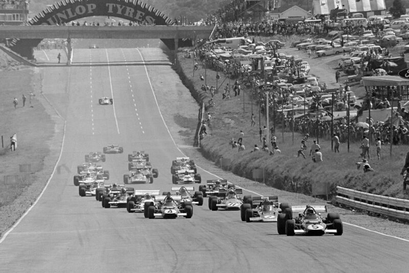 Mario Andretti's Ferrari leads the field into the first corner at the start of the 1971 South African Grand Prix.