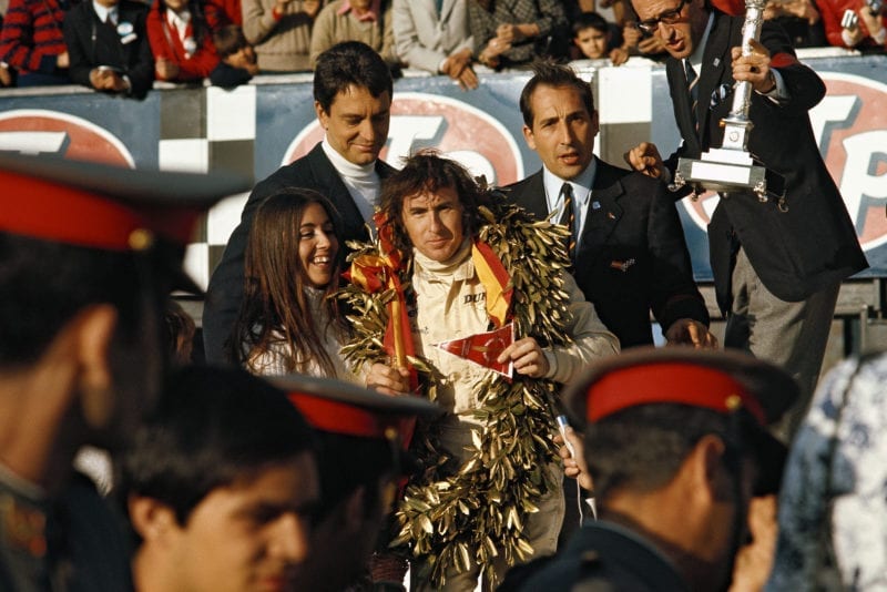 Jackie Stewart celebrates his 1970 Spanish Grand Prix victory on the podium