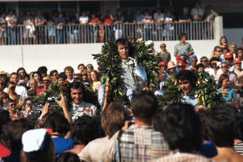 Jackie Stewart stands on the podium after winning the 1971 French Grand Prix.
