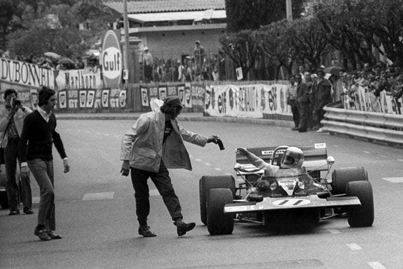 Jackie Stewart is handed a drink as he pulls up after winning the 1971 Monaco Grand Prix.