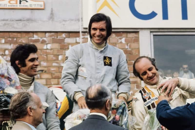 Emerson Fittipaldi celebrates his 1972 Belgian grand Prix victory on the podium.