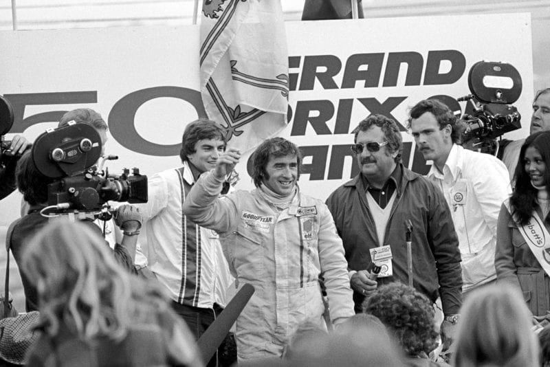 Jackie Stewart celebrates winning the 1972 Canadian Grand Prix for Tyrrell on the podium.