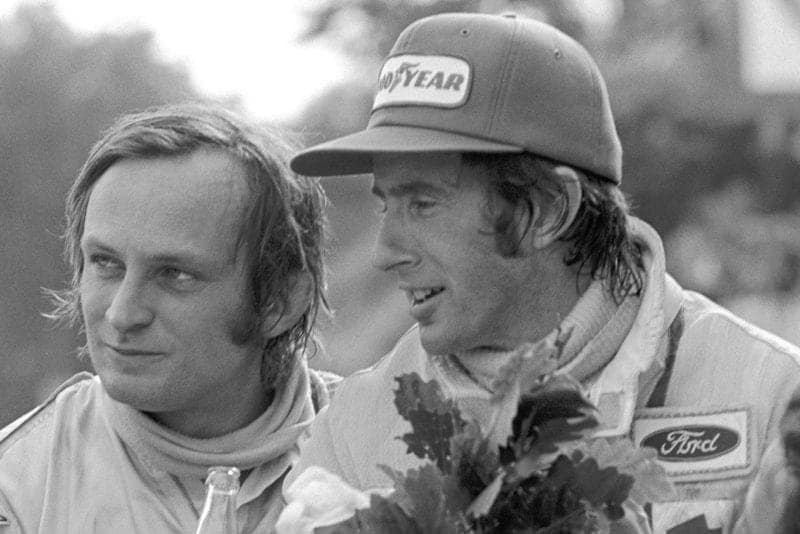 Jackie Stewart and Chris Amon celebrate on the podium at the 1972 French Grand Prix.