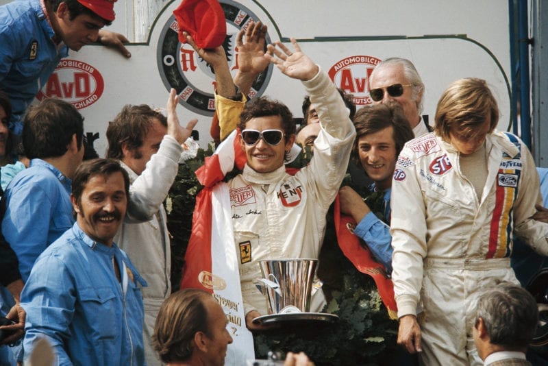 Ferrari's Jacky Ickx waves from the podium after winning the 1972 German Grand Prix, Nurbrugring.