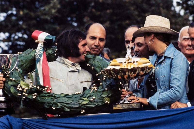 Emerson Fittipaldi receives the winner's trophy on the podium at the 1972 Italian Grand Prix, Monza.