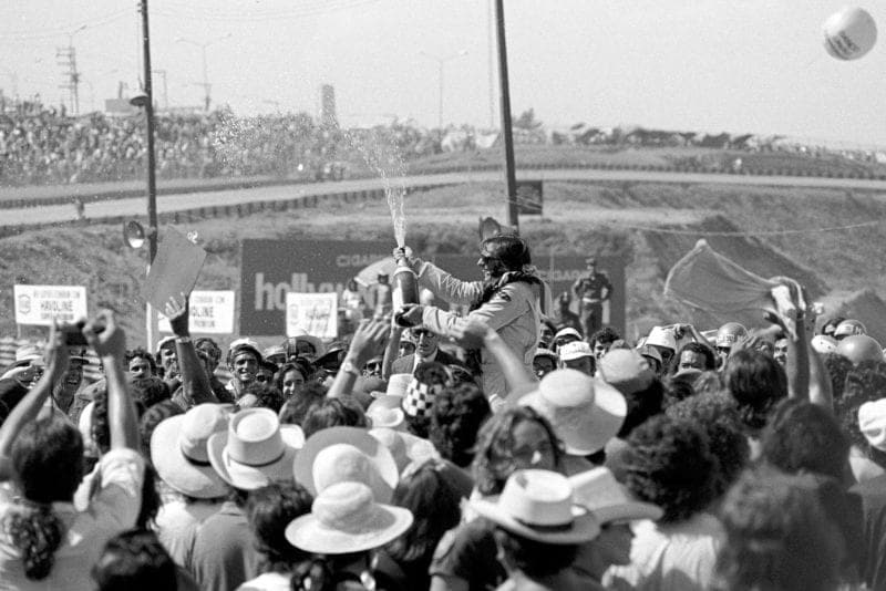 Emerson Fittipaldi (Lotus) sprays the champagne on the podium after winning the 1973 Brazilian Grand Prix.