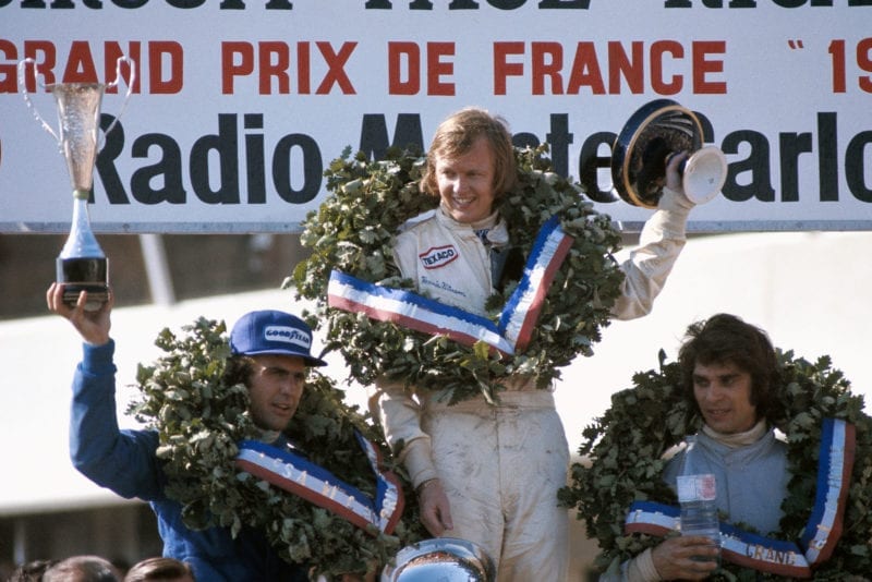 Ronnie Peterson celebrates his win on the podium at the 1973 French Grand Prix, Paul Ricard.