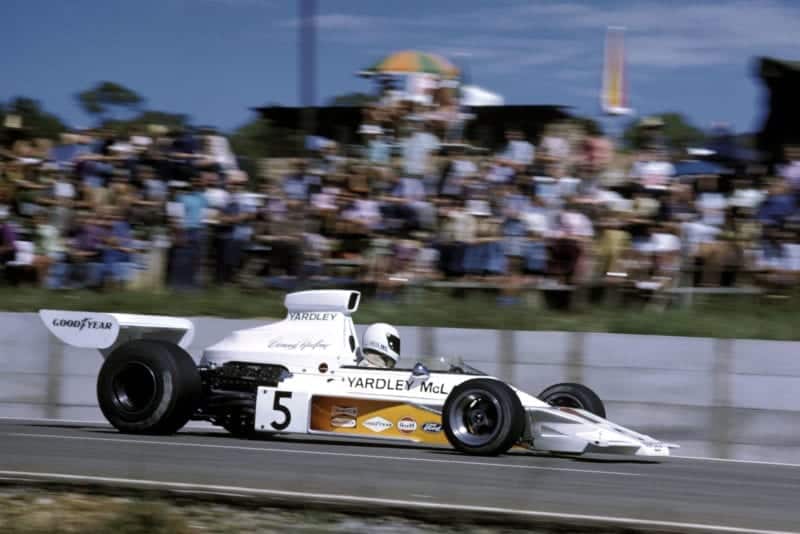 Denny Hulme (McLaren) driving at the 1973 South African Grand Prix, Kyalami.