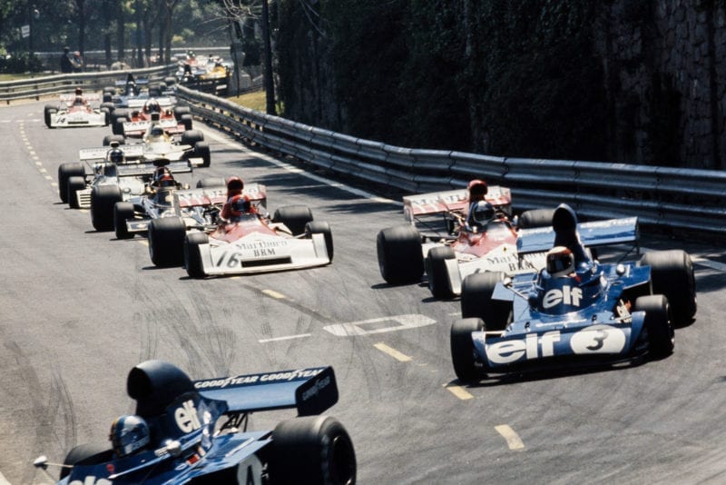 Cars thread through the narrow street circuit of Montjuïch Park at the 1973 Spanish Grand Prix.