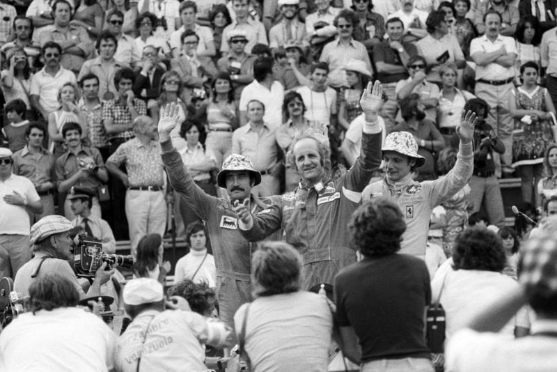 Denny Hulme waves from the podium after winning the 1974 Argentine Grand Prix.