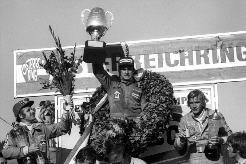 Carlos Reutemann (Brabham) holds his trophy aloft after winning the 1974 Austrian Grand Prix.
