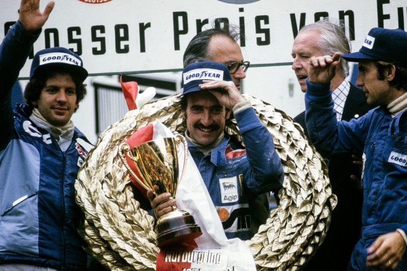 Clay Regazzoni smiles on the podium after winning the 1974 German Grand Prix, Nurburgring.