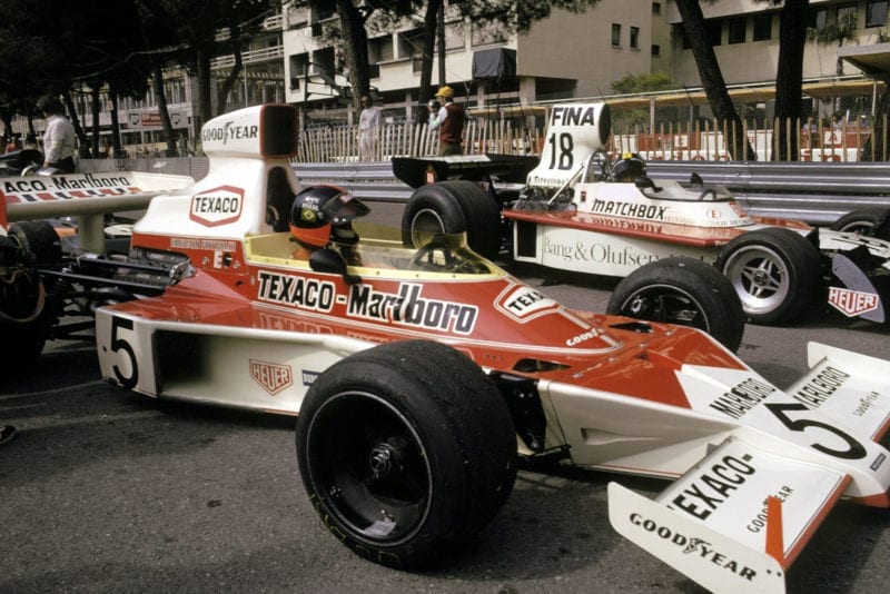 Emerson Fittipaldi sits in his McLaren on the starting grid at the start of the 1974 Monaco Grand Prix.