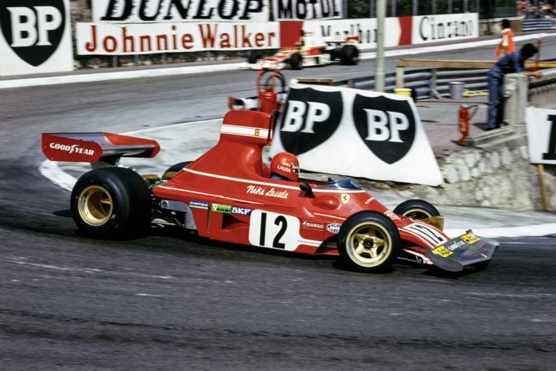 Niki Lauda rounds Loews in his Ferrari a