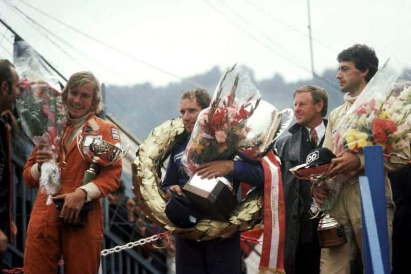 Vittorio Brambilla stands on the podium after winning the 1975 Austrian Grand Prix, Osterreichring.