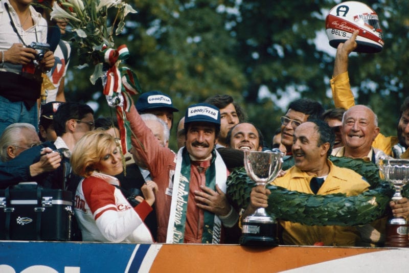 Clay Regazzoni holds his bouquet aloft after winning the 1975 Italian Grand Prix, Monza.