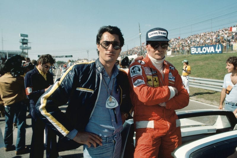 Niki Lauda (Ferrari) stands next to Scuderia team boss Daniele Audetto.
