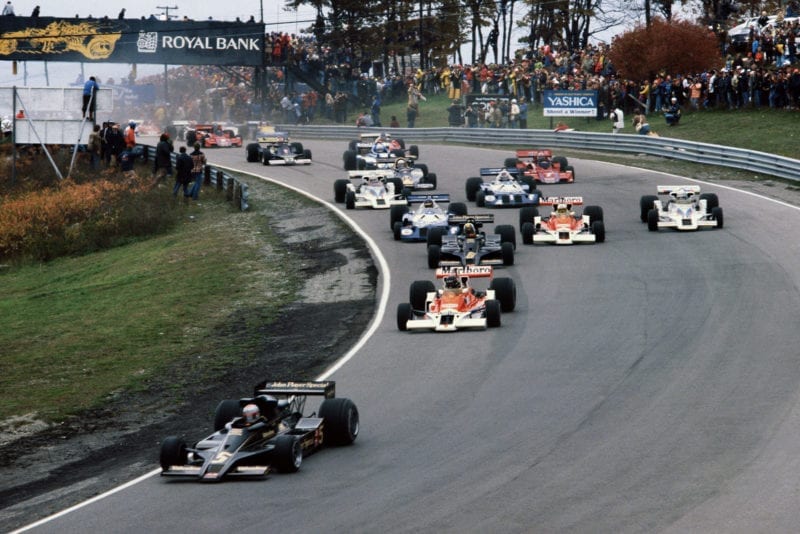 Mario Andretti (Lotus) leads the field on lap 1 at the 1977 Canadian Grand Prix, Mosport Park.
