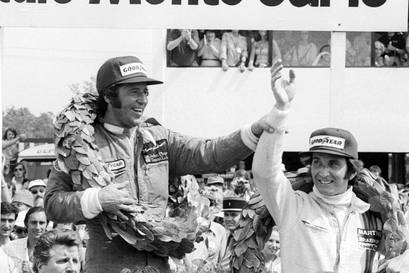 Mario Andretti (Lotus) celebrates on the podium after winning the 1977 French Grand Prix, Dijon.
