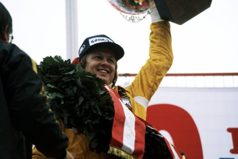 Ronnie Peterson celebrates on the podium after winning the 1978 Austrian Grand Prix, Österreichring.
