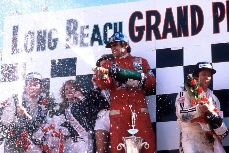 Carlos Reutemann (Ferrari) sprays champagne on the podium at the 1978 United States Grand Prix West, Long Beach.