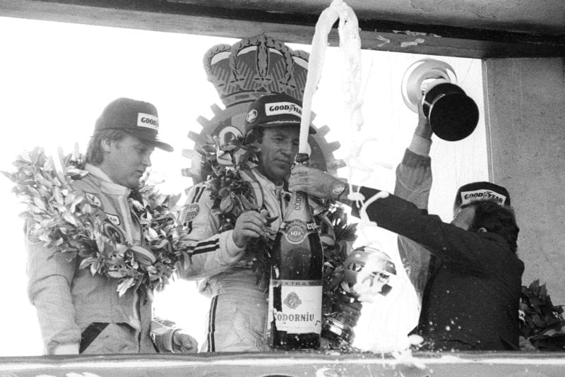 Mario Andretti (Lotus) celebrates his win on the podium at the 1978 Spanish Grand Prix, Jarama.