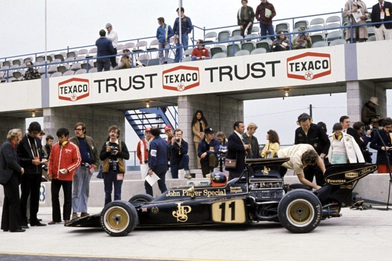 Emerson Fittipaldi sits in his Lotus in the pitlane at the 1972 United States Grand Prix, Watkins Glen.