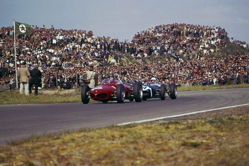 Richie Ginther in a Ferrari Dino 156) leads Stirling Moss in his Lotus 18-Climax.