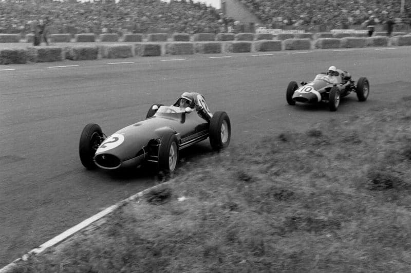 Tony Brooks driving a Ferrari Dino 24 leads Maurice Trintignant in his Cooper T51-Climax.