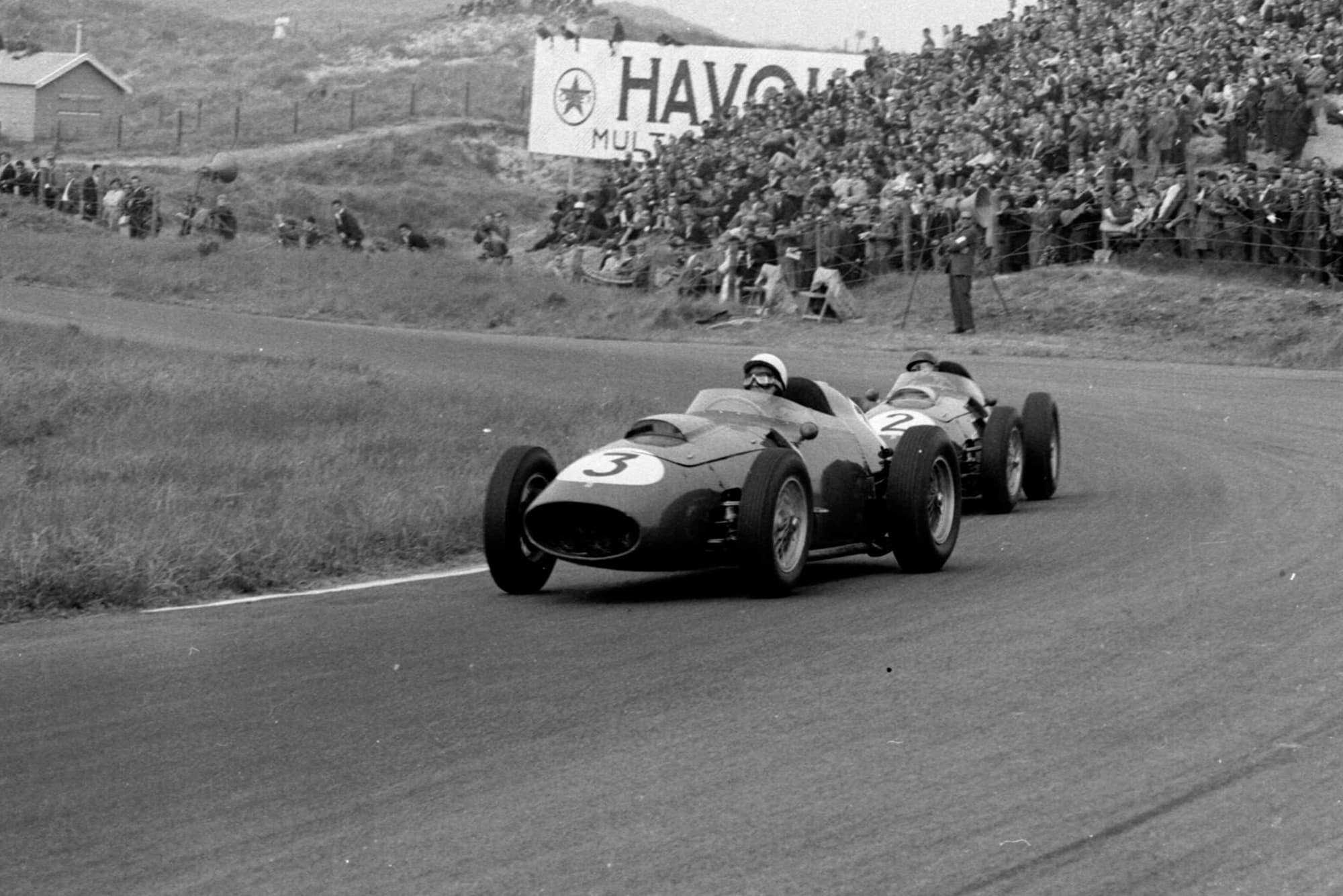 Phil Hill leads Tony Brooks, both driving Ferrari Dino 246s.
