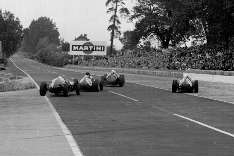 Jo Bonnier driving a BRM P25 leads Dan Gurney and Phil Hill in Ferrari Dino 246) and Bruce McLaren in hisCooper T45 Climax out of the Hairpin.
