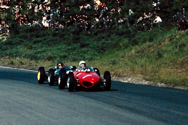 Jim Clark at the wheel of a Lotus 21 chasing Phil Hill in his Ferrari 156.