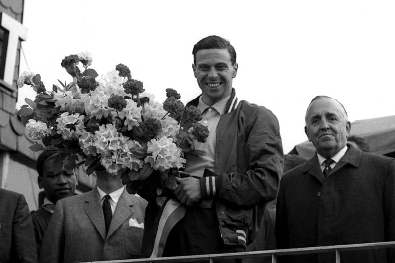 Race winner Jim Clark celebrates victory on the podium.