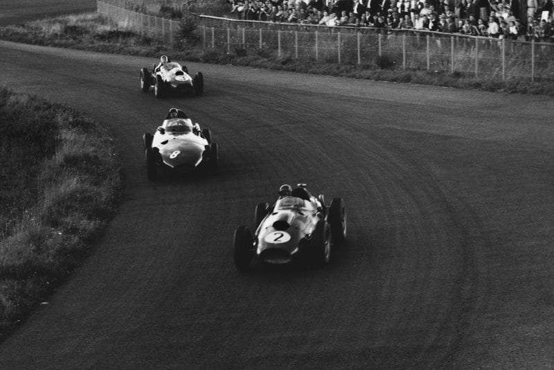Peter Collins in his Ferarri Dino 246leads Tony Brooks in a Vanwall and Mike Hawthorn in his Ferrari Dino 246.