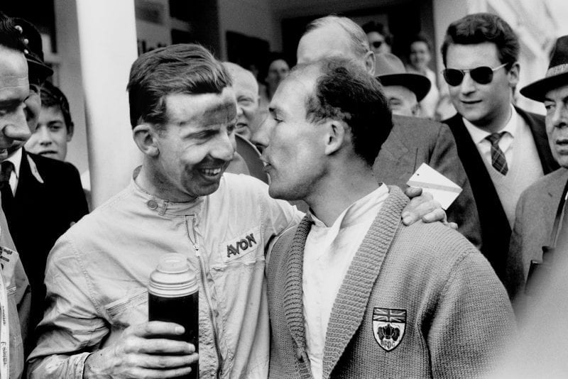 Winner Tony Brooks drinks from a flask with Vanwall team mate Stirling Moss who retired from the race.