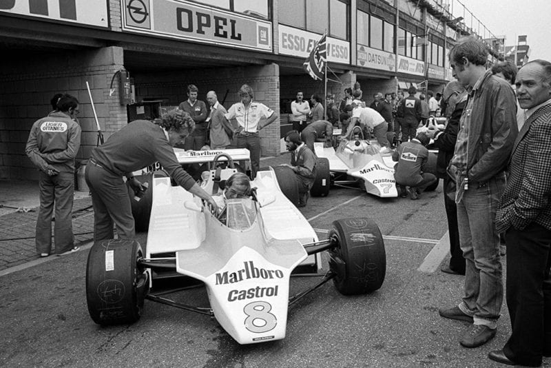 (L to R): The new McLaren M30 of sixth placed Alain Prost (FRA) in the pits with the McLaren M29B of his team mate John Watson (GBR), who retired from the race on lap 19 with a blown engine.
