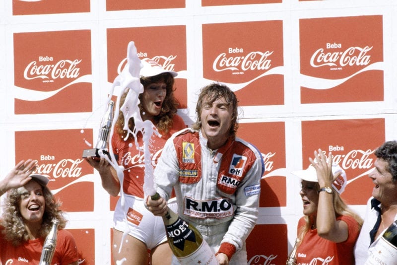 Rene Arnoux (Renault RE20) on the Podium after winning.