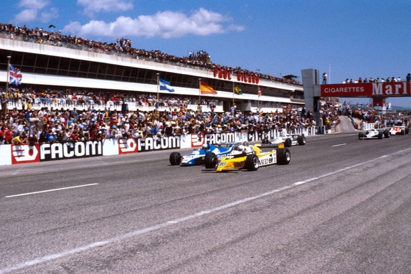 Rene Arnoux in a Renault RE20 leads Didier Pironi in his Ligier JS11/15 Ford and Carlos Reutemann in his Williams FW07B Ford at the start.