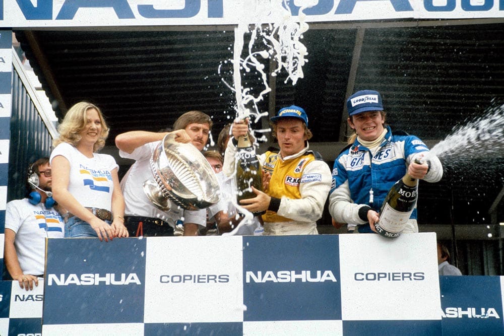 French 1-2-3, Winner Rene Arnoux in a Renault, 3rd placed Didier Pironi in his Ligier and Jacques Laffite (2nd) hidden behind trophy.