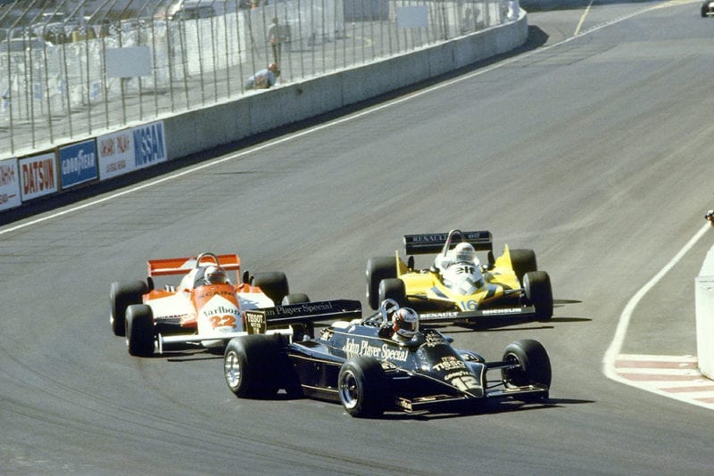 Nigel Mansell (Lotus 87-Ford Cosworth) leads Mario Andretti (Alfa Romeo 179C) and Rene Arnoux (Renault RE30).