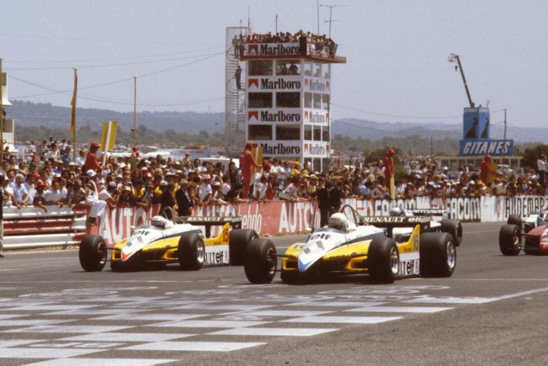 Rene Arnoux and Alain Prost (both Renault RE30B's) lead the rest of the field away from the front row at the start.