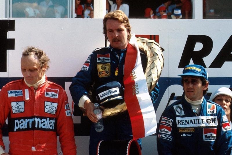 The podium (L to R): Niki Lauda (third); Keke Rosberg (first time winner) Alain Prost in second.