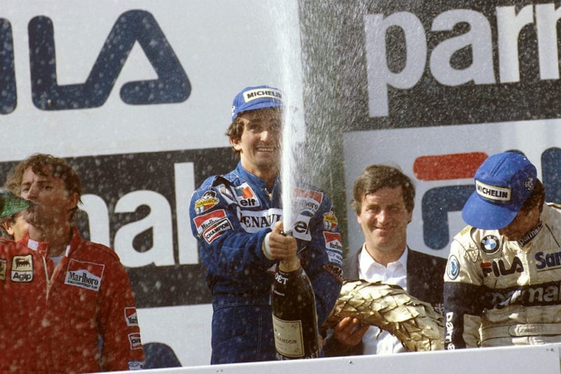 Alain Prost, 1st position, Rene Arnoux, 2nd position and Nelson Piquet, 3rd position on the podium.
