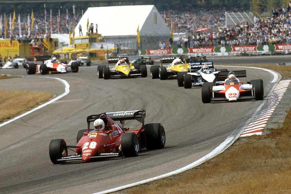Rene Arnoux (Ferrari 126C3) leads Andrea de Cesaris (Alfa Romeo 183T), Nelson Piquet (Brabham BT52B BMW), Alain Prost and Eddie Cheever (both Renault RE40's) into the Sudkurve.