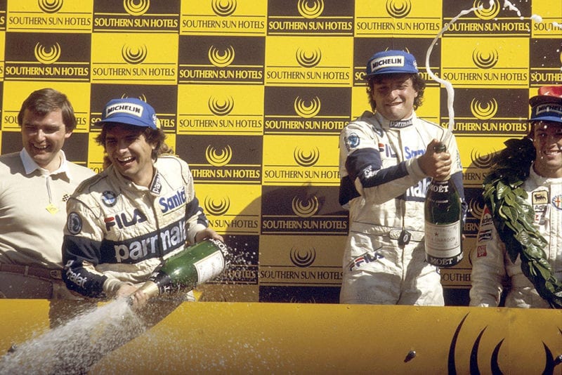Riccardo Patrese 1st position, Andrea de Cesaris 2nd position and Nelson Piquet 3rd position on the podium.