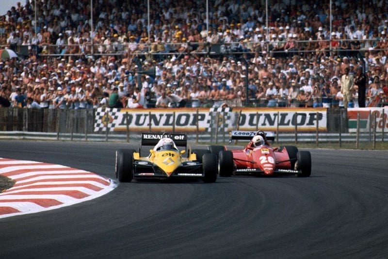 Alain Prost (Renault RE40) goes past the Ferrari of Rene Arnoux.