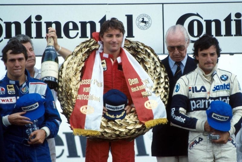 Rene Arnoux (1st place) flanked by Andrea de Cesaris, left, 2nd place and Riccardo Patrese, right, 3rd place.