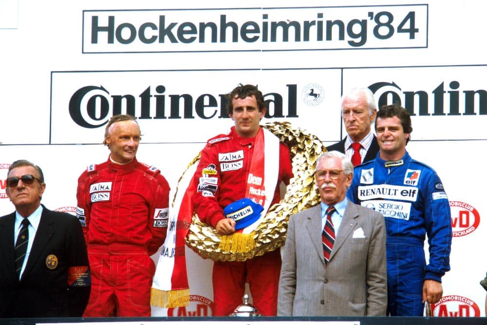 (L-R)Niki Lauda, Winner Alain Prost, and Derek Warwick on the podium.